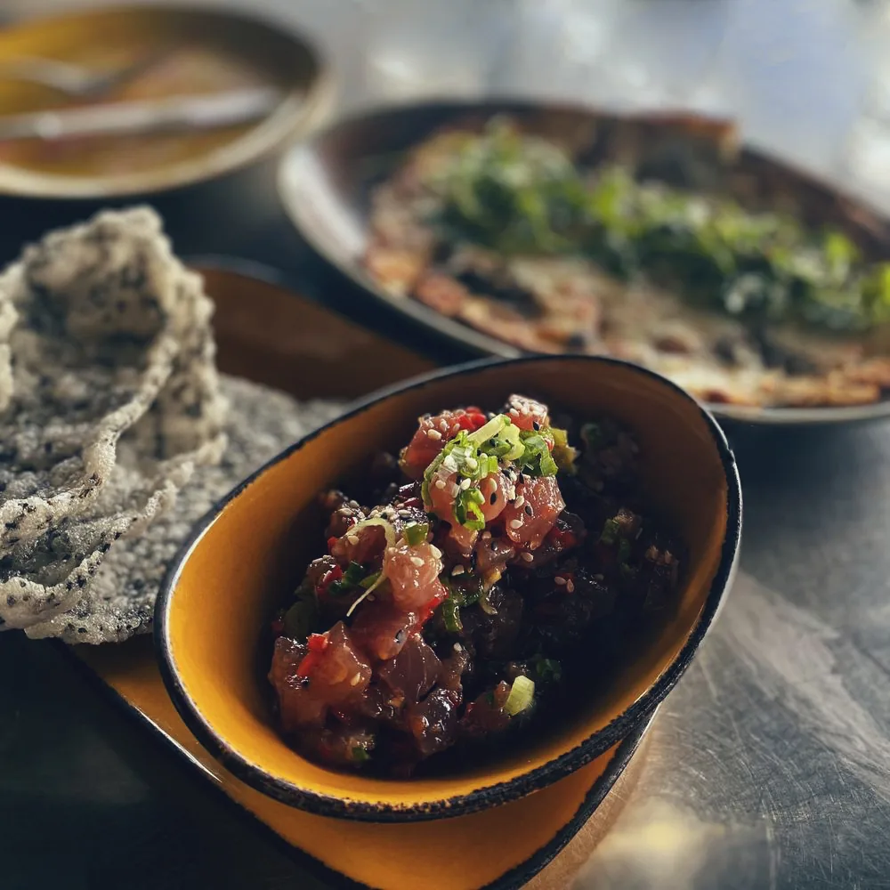 Flatbread and wine glasses set on a table